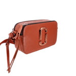 Rust leather snapshot camera bag, side view with top zipper and front J logo