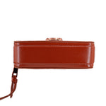 Rust leather snapshot camera bag side profile with zipper top and strap loop