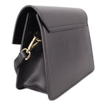 Black crossbody bag profile view with gold clasp hardware and side stitching