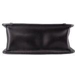 Black crossbody bag bottom edge view with structured base