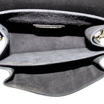 Open black crossbody bag interior with gray lining and side seam edges