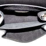 Open black crossbody bag interior with gray lining and side seam edges