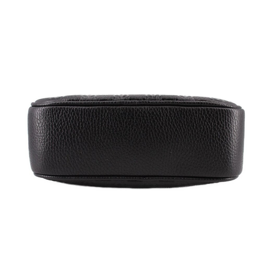 Black leather crossbody bag back view, smooth pebbled texture