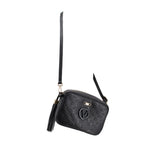 Small black monogram crossbody bag with crossbody strap, V logo, and tassel
