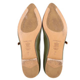 Leather soles of green flats with tan heel patches and printed size markings