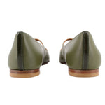 Back view of green leather flats showing stitched heel seams and low stacked heels