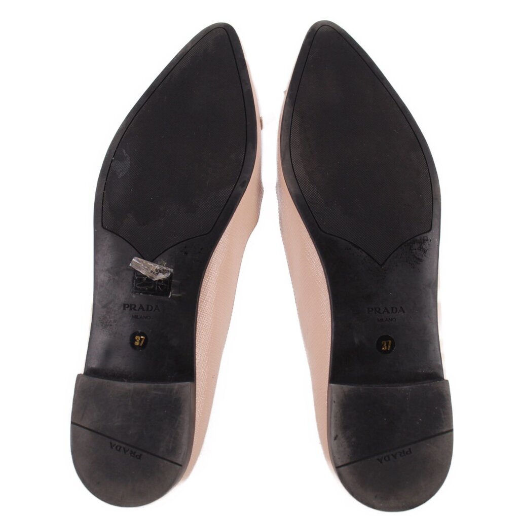 Pair of PRADA flats viewed from below, showing black soles and size 37 marks
