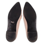 Pair of PRADA flats viewed from below, showing black soles and size 37 marks