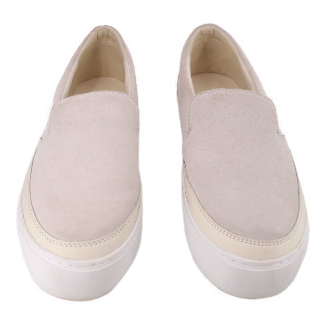 Pair of cream suede UGG slip-on flats with thick white soles