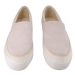 Pair of cream suede UGG slip-on flats with thick white soles