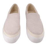 Pair of cream suede UGG slip-on flats with thick white soles