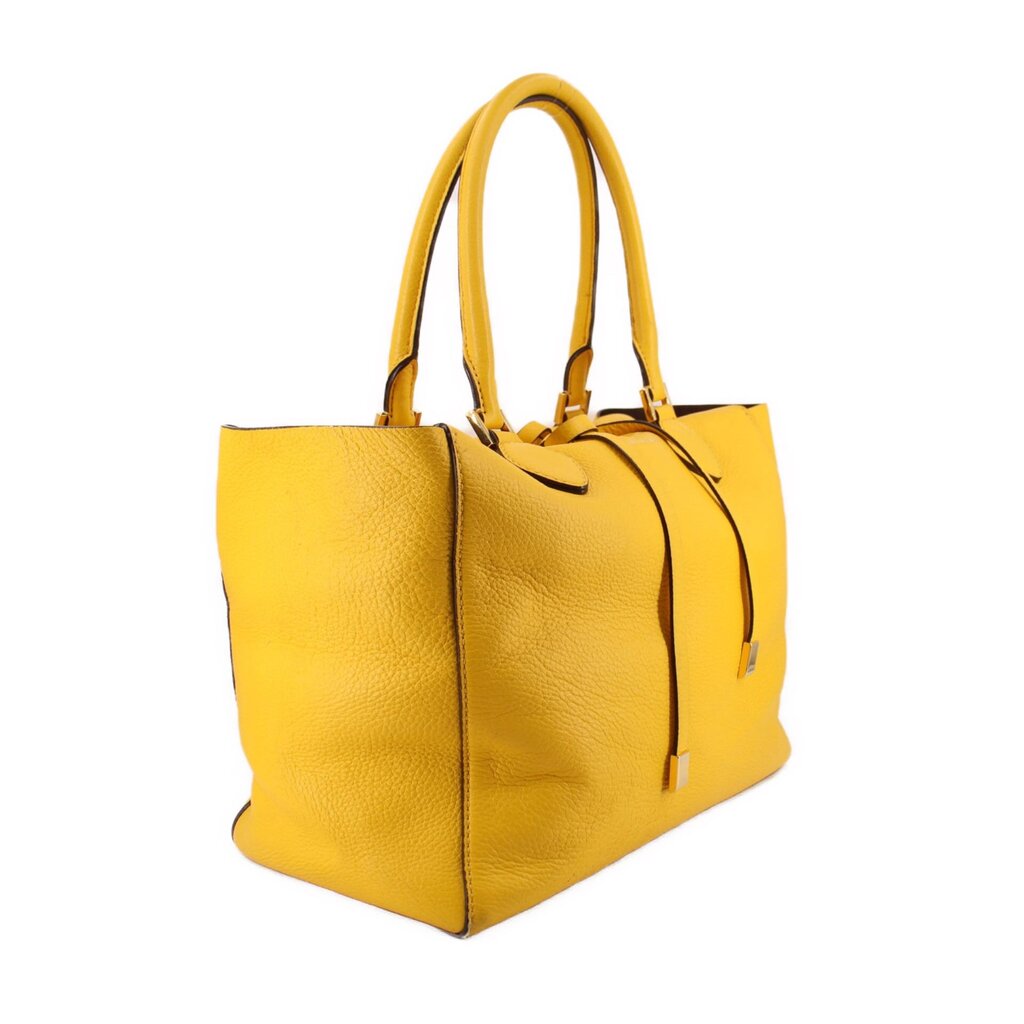 Yellow pebbled leather tote, angled view showing its side gusset and double handles