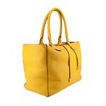 Yellow pebbled leather tote, angled view showing its side gusset and double handles