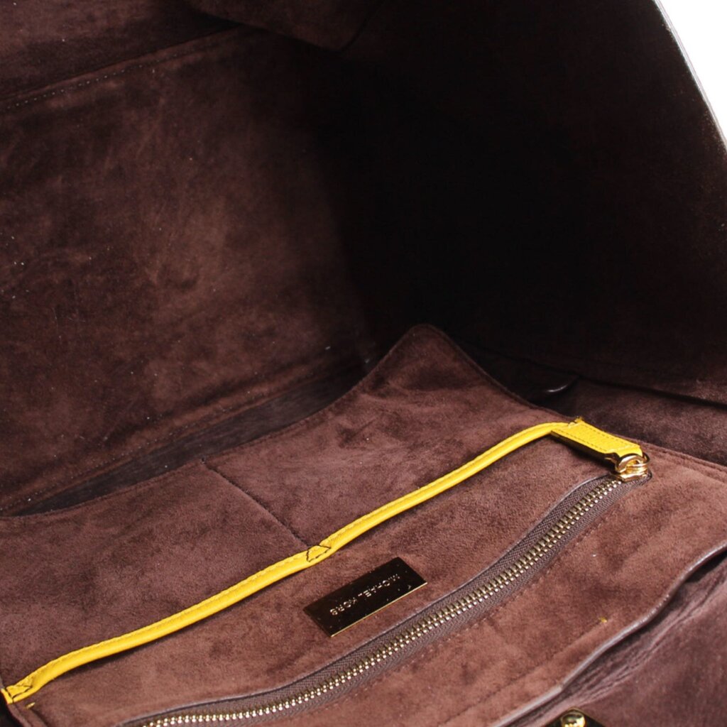 Tote interior with brown lining, zip pocket, and MICHAEL KORS label