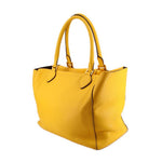 Yellow pebbled leather tote, angled view of the side panel and open top