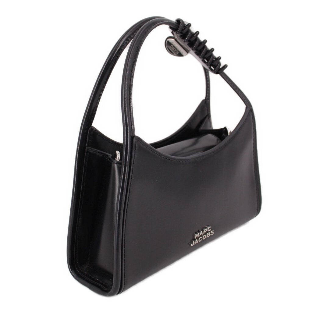 MARC JACOBS black bag shown from the side, with claw clip handle and open top