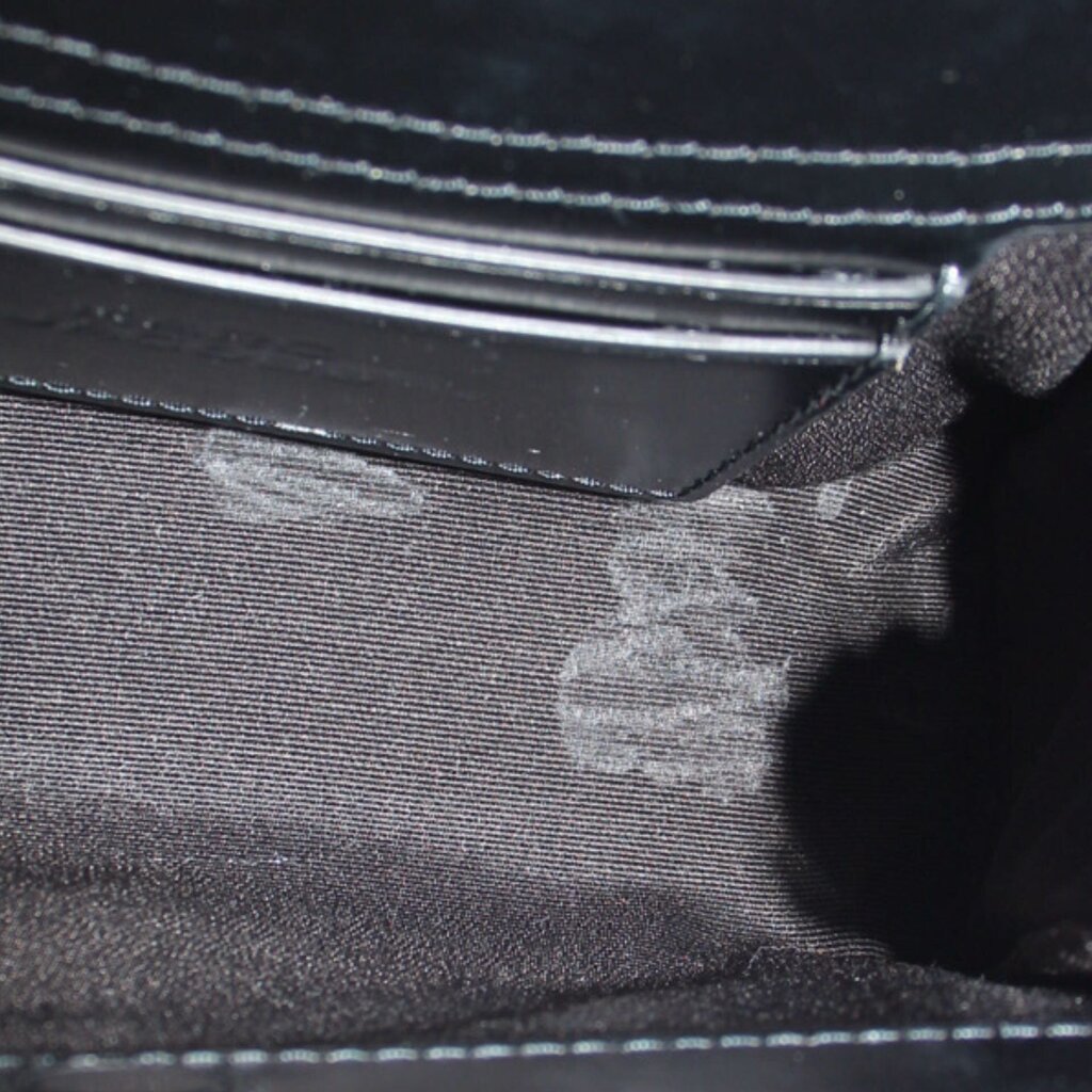 Close-up of the bag's dark fabric lining and interior zipper pocket