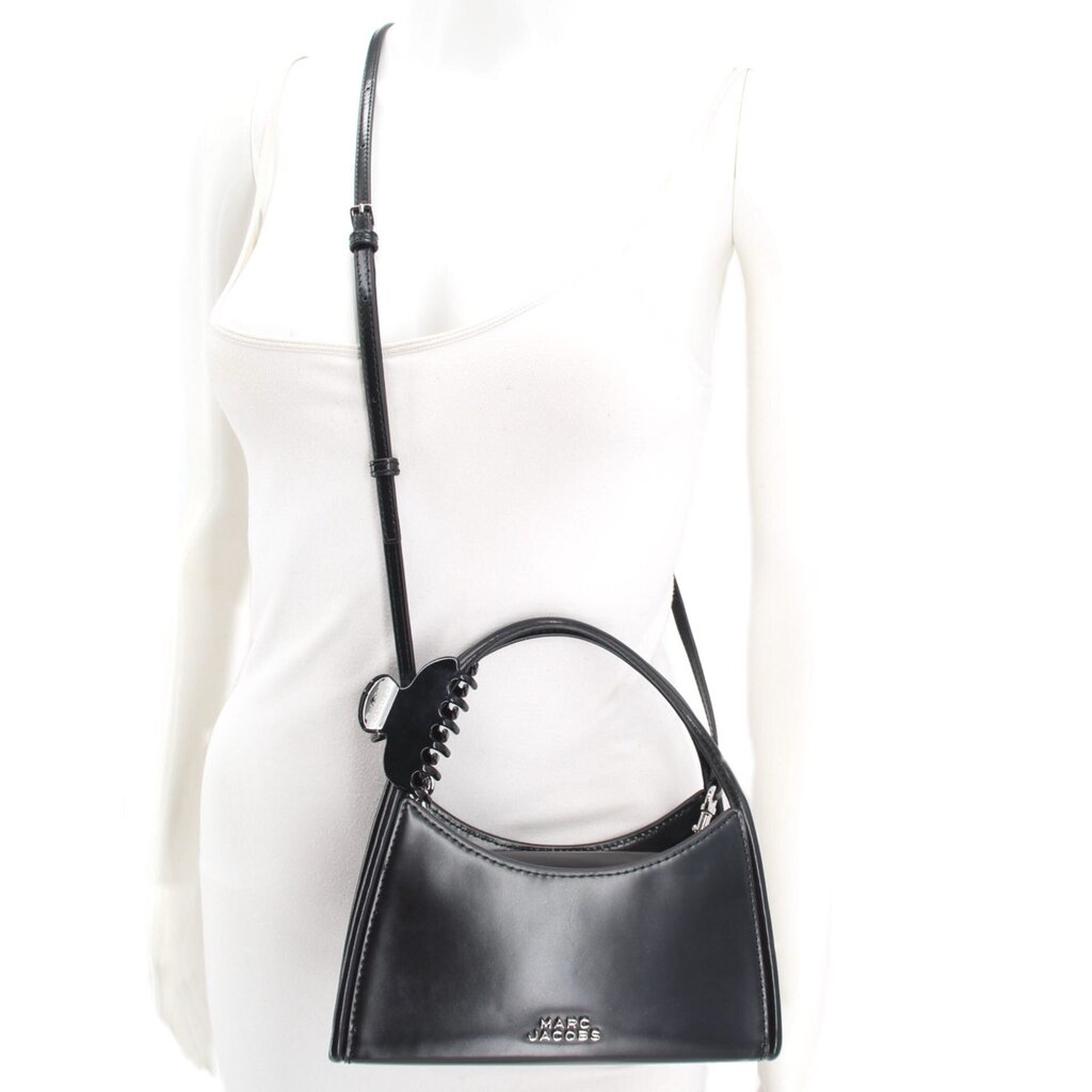 MARC JACOBS black crossbody bag worn with its adjustable long strap