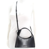 MARC JACOBS black crossbody bag worn with its adjustable long strap