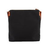 Dooney & Bourke black nylon crossbody bag showing its plain back panel and brown strap tabs