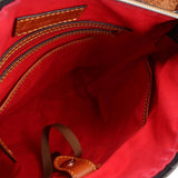 Dooney & Bourke crossbody bag interior with red lining, zip pocket, and slip pockets