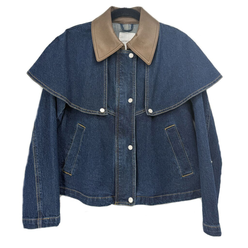 Blue denim jacket with a tan collar, cape-style overlay, front buttons, and slanted pockets