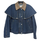 Blue denim jacket with a tan collar, cape-style overlay, front buttons, and slanted pockets