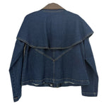 Back of a blue denim jacket with a cape-style overlay and stitched V-shaped yoke