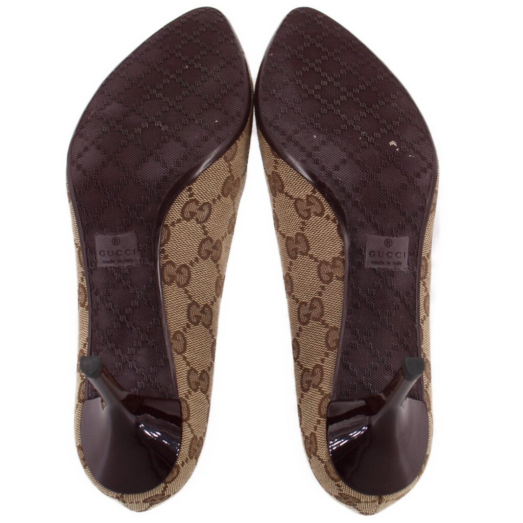 Pair of GUCCI brown GG monogram pumps showing patterned soles