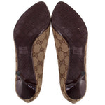 Pair of GUCCI brown GG monogram pumps showing patterned soles