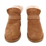Pair of brown suede booties shown from the front, with fleece lining and folded cuffs