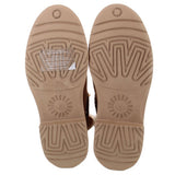 Pair of booties with tan rubber soles featuring deep patterned treads