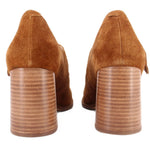 Pair of brown suede Mary Jane heels showing the stacked block heels and back seams