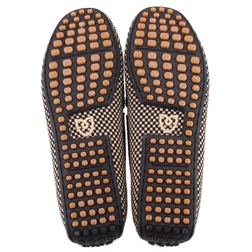 Pair of loafers showing black soles with tan rubber grip studs