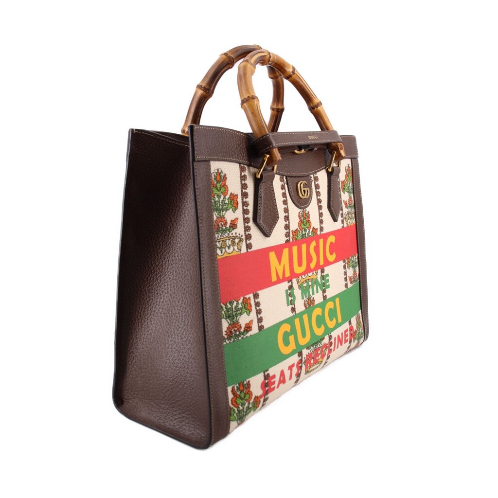 GUCCI tote shown at an angle, with dark brown leather sides and bamboo handles