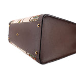 GUCCI tote base close-up showing brown leather construction and gold feet