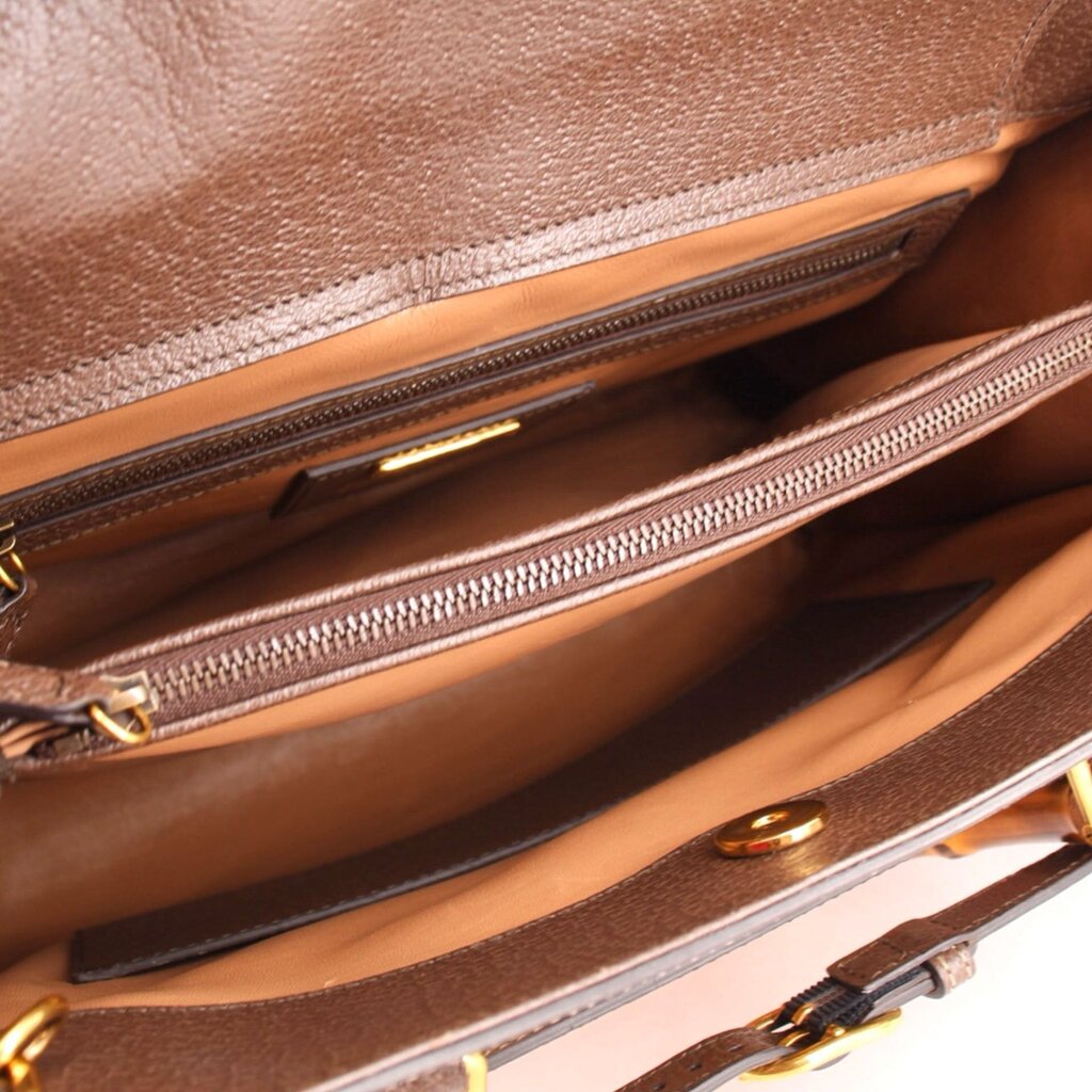 GUCCI tote interior with brown lining, zip pocket, and central zip divider