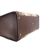 GUCCI tote base close-up with textured brown leather and gold protective feet
