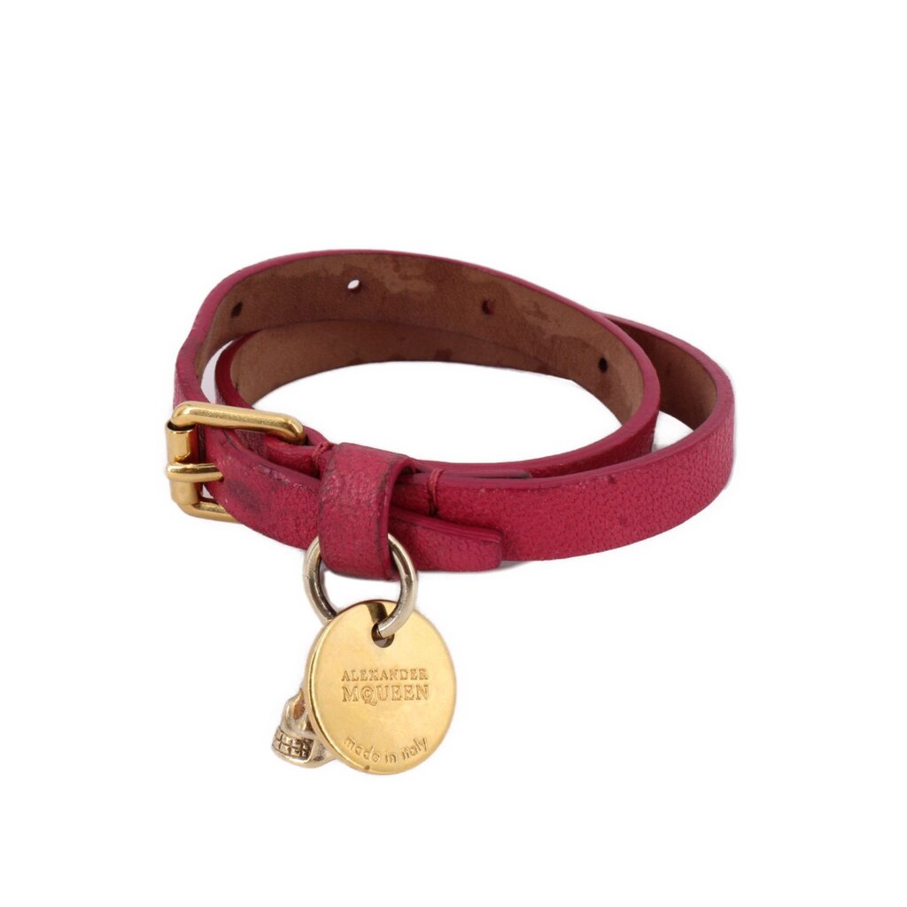 Pink leather wrap bracelet with gold-tone skull charm and branded medallion