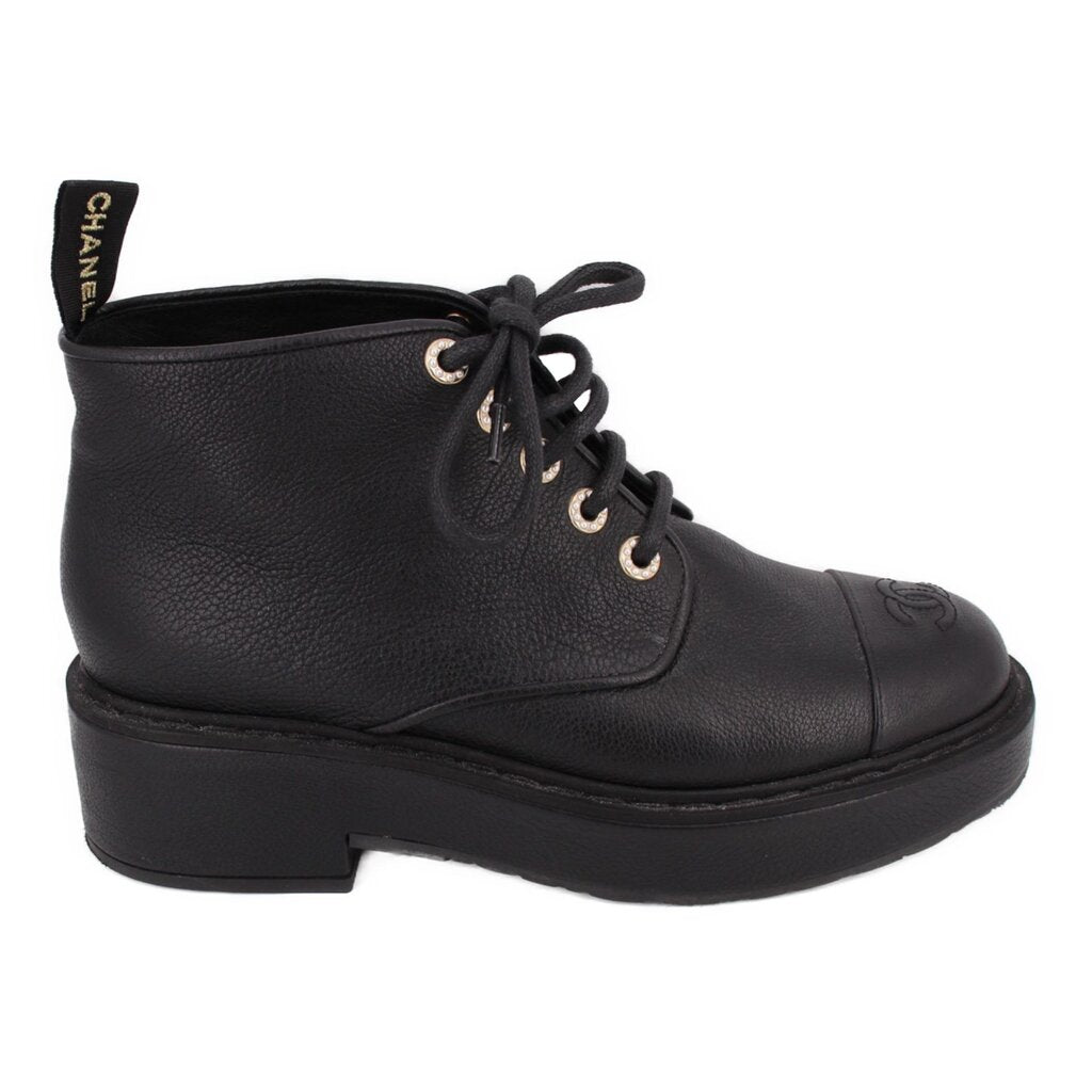 CHANEL black leather ankle boot in side view, with lace-up front and thick platform sole