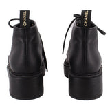 Pair of CHANEL black ankle boots shown from the back, with pull tabs and platform heels