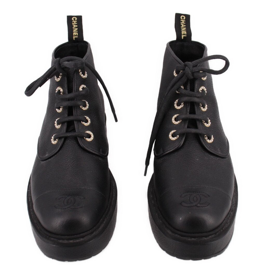 Pair of CHANEL black lace-up platform ankle boots shown from the front