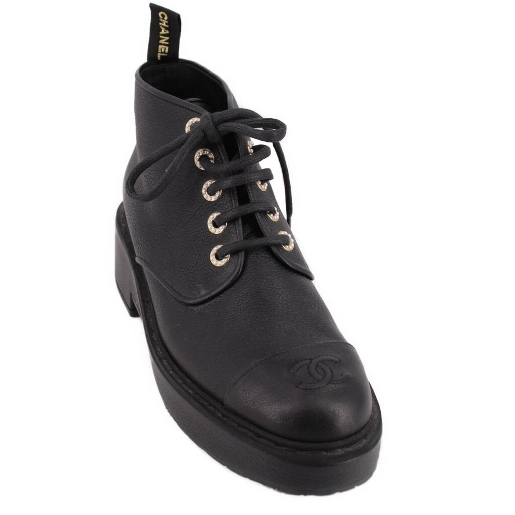 CHANEL black leather platform ankle boot with lace-up front, metal eyelets, and logo toe