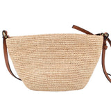 LOEWE raffia crossbody bag shown from the plain back, with tan leather strap