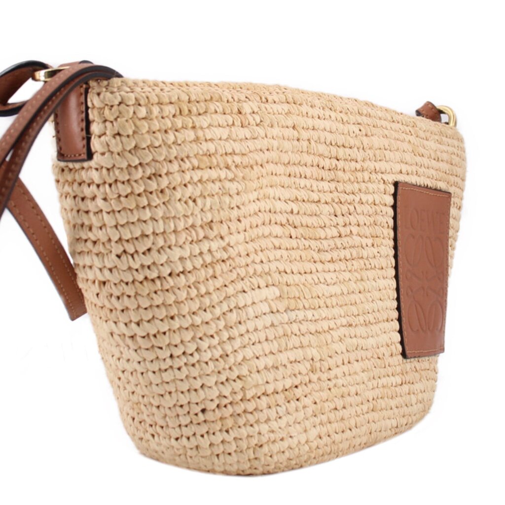 LOEWE natural raffia crossbody bag, close view of woven texture and leather logo patch