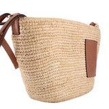 LOEWE natural raffia crossbody bag, close view of woven texture and leather logo patch