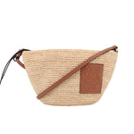 LOEWE raffia crossbody bag with tan leather strap and embossed logo patch