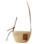 LOEWE raffia crossbody bag with adjustable tan leather strap and embossed logo patch