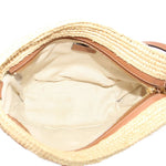 LOEWE raffia crossbody bag open, showing light fabric lining and zip closure