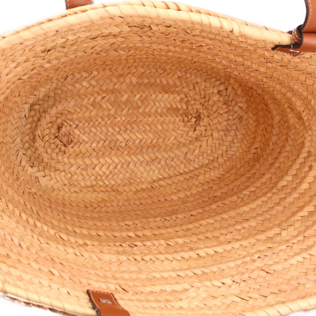 LOEWE tote interior with woven palm-leaf lining and leather handle attachments